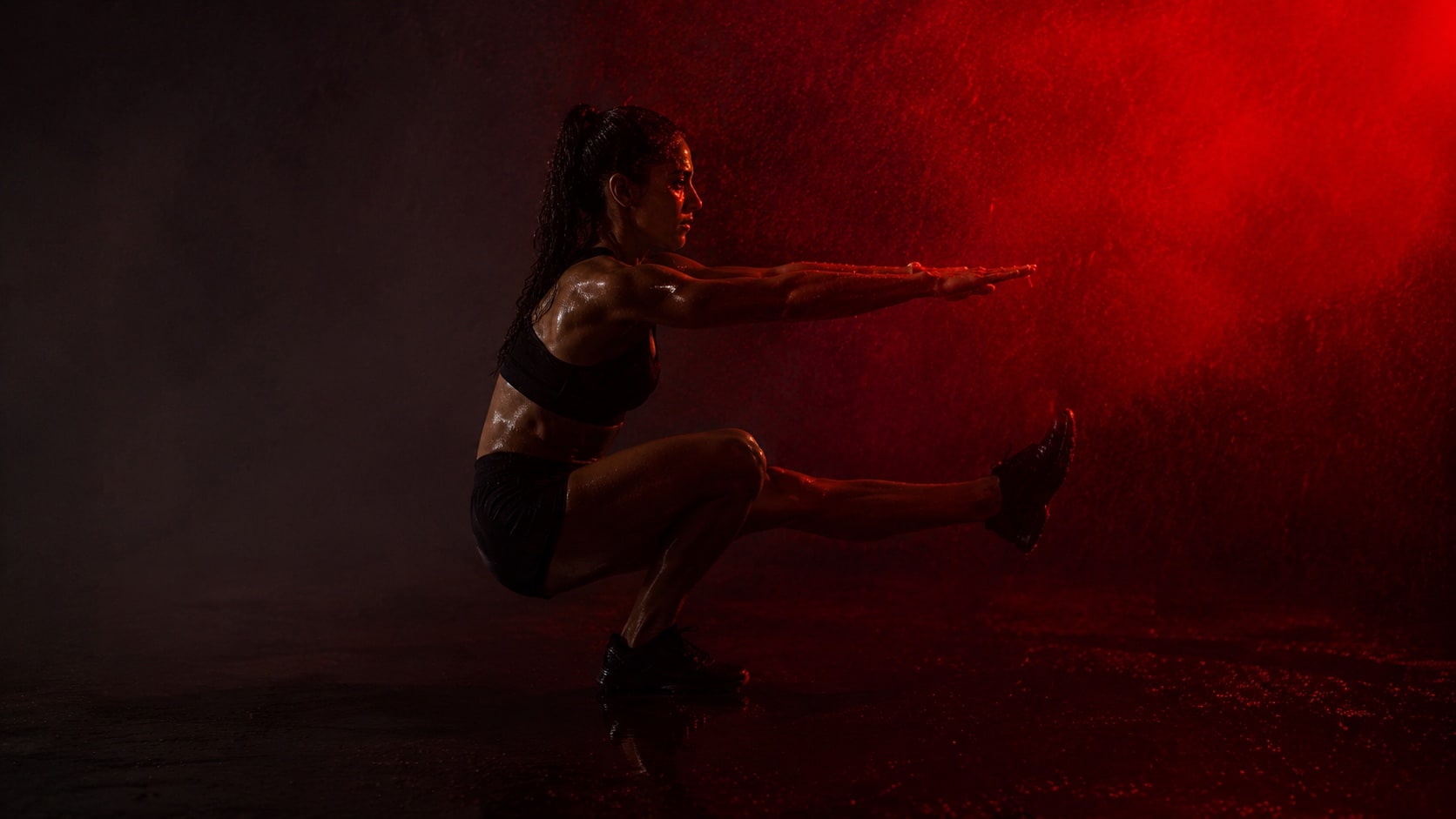 Athlete holding the bottom of a single-leg squat, arms extended